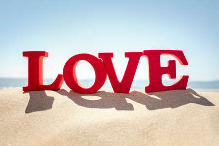 Love word on a sand beach concept for romance or romantic vacation and holidayの写真素材