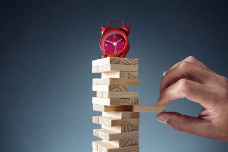 Planning, risk and strategy deadline time in business alarm clock on wooden blocksの写真素材