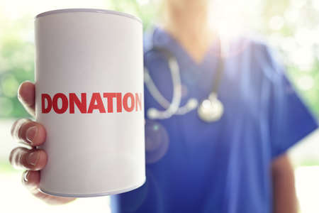 Doctor holding a donation boxの写真素材
