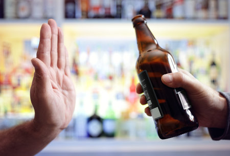Hand rejecting alcoholic beer beverage concept for alcoholism and addictionの写真素材