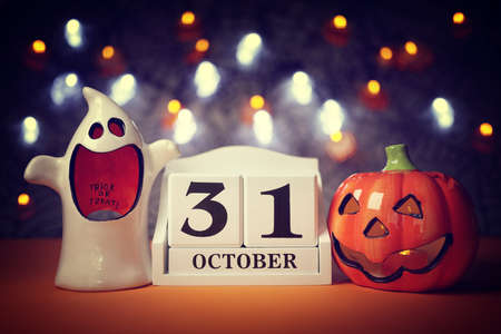 Halloween calendar date 31st October with pumpkin and ghostの写真素材
