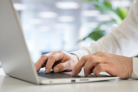 Businessman using laptop computer in office