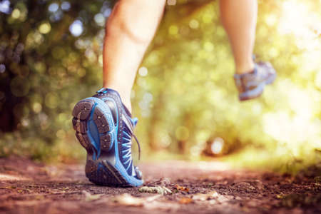 Outdoor cross-country running in summer sunshine concept for exercising, fitness and healthy lifestyleの写真素材