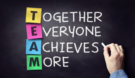 Team - together everyone achieves more written on blackboard