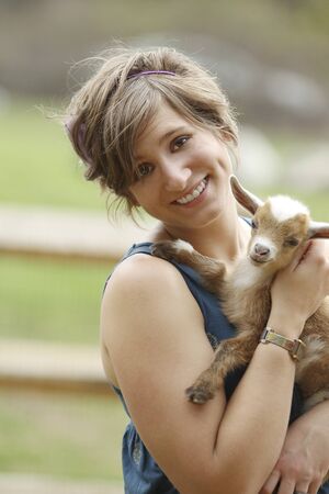 Youth Woman and Baby Goat at the farm.の写真素材