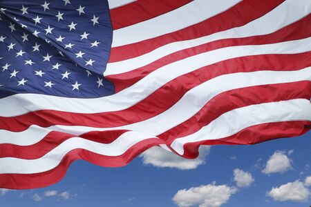 An American flag flowing in the wind.の写真素材