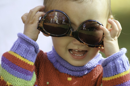 Little Girl Wearing Sunglasses upside down!の写真素材