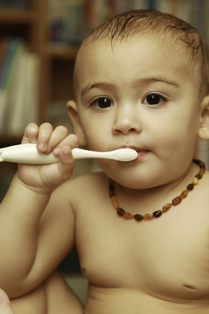 One and Half Years Old Baby Girl Brushing Her Teeth after a Showerの写真素材