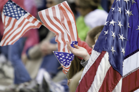 Children waving US  flags  at holiday celebrationの写真素材
