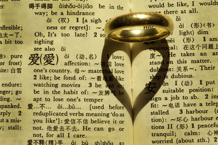 Wedding Ring on the dictionary with Chinese Word 'love'の写真素材