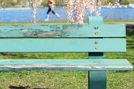 Bench and Jogger in the park.の写真素材