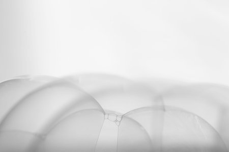 Many soap bubbles piled on white background in details