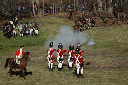 Memorial Day Celebration - Parker Revenge Battle Demonstration held in Lexington, MA on Sunday, April 20, 2014.Hundreds of British and Colonial Re-enactors engaged in a tactical weapons demonstration showing the running battle that took place along this dのeditorial素材