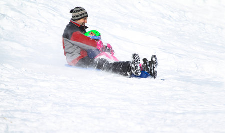 Families went snow sledding at McClennen Park, Arlington, Massachusetts, US on Jan 30, 2022 after the historical snowstormのeditorial素材