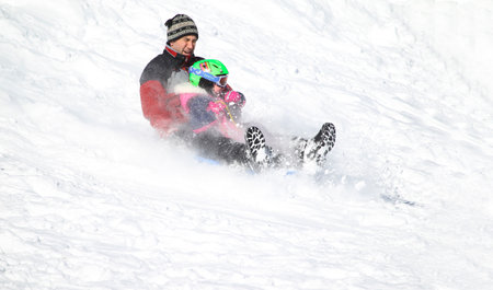 Families went snow sledding at McClennen Park, Arlington, Massachusetts, US on Jan 30, 2022 after the historical snowstormのeditorial素材