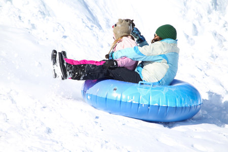 Families went snow sledding at McClennen Park, Arlington, Massachusetts, US on Jan 30, 2022 after the historical snowstormのeditorial素材