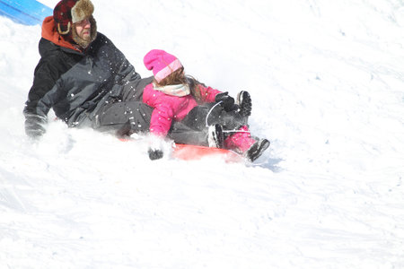 Families went snow sledding at McClennen Park, Arlington, Massachusetts, US on Jan 30, 2022 after the historical snowstormのeditorial素材