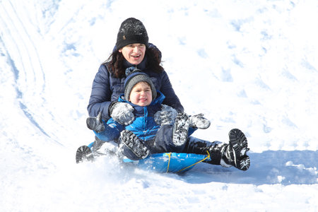 Families went snow sledding at McClennen Park, Arlington, Massachusetts, US on Jan 30, 2022 after the historical snowstormのeditorial素材