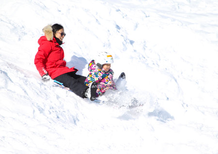Families went snow sledding at McClennen Park, Arlington, Massachusetts, US on Jan 30, 2022 after the historical snowstormのeditorial素材