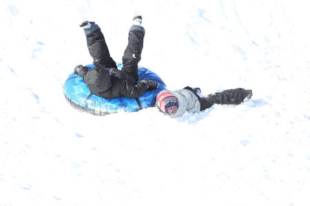 Families went snow sledding at McClennen Park, Arlington, Massachusetts, US on Jan 30, 2022 after the historical snowstormのeditorial素材