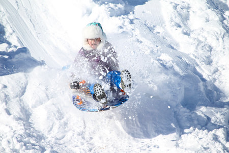 Families went snow sledding at McClennen Park, Arlington, Massachusetts, US on Jan 30, 2022 after the historical snowstormのeditorial素材