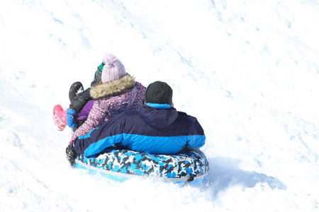 Families went snow sledding at McClennen Park, Arlington, Massachusetts, US on Jan 30, 2022 after the historical snowstormのeditorial素材