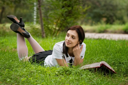 Beautiful young brunette woman with note at outdoorの写真素材