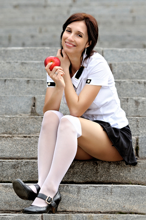 Young student eating appleの写真素材