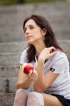Young student eating appleの写真素材
