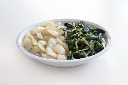 swiss chard cooked on white background, front view of dish with vegan foodの写真素材
