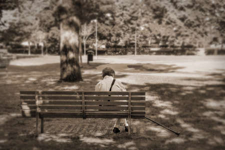 old man alone at the park, lonely grandfather sadness conceptの写真素材