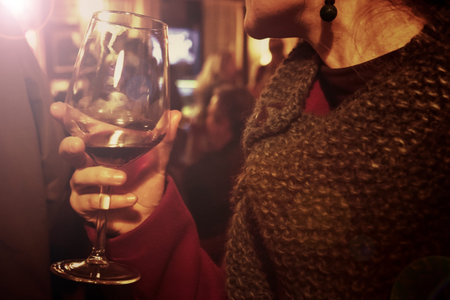 woman drinking wine, woman at the bar enjoys drinking (warm tone effect)