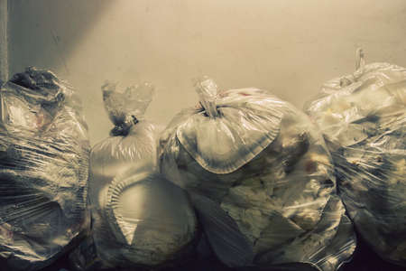 bags of stinky trash, garbage abandoned on the roadの写真素材
