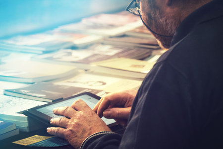 man at library using tablet, closeup of person with touch technology device (image with copy space)