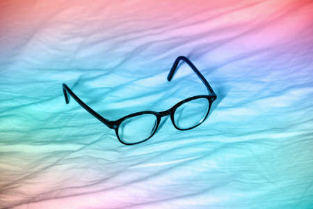 eye glasses on colored background, the object is on a waved velvetの写真素材