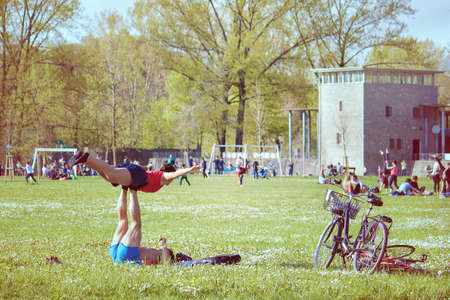 Acroyogis practicing Acro Yoga in a park. Healthy Lifestyle Outdoorのeditorial素材