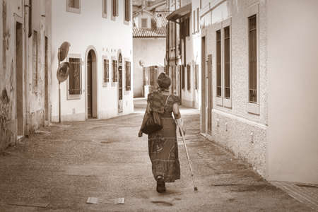 invalid african woman, ethnic female walkingの写真素材