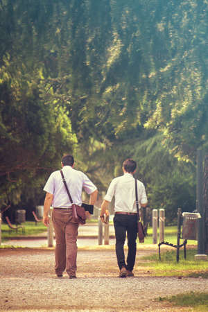 two businessmen walking, vertical image of elegant people on footの写真素材