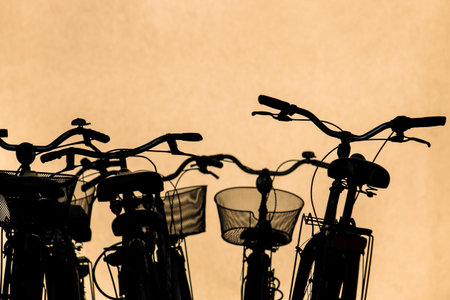 parked city bikes, silhouette of bicycles (urban transportation concept)