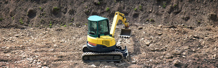under construction, horizontal picture of an excavator in a yard