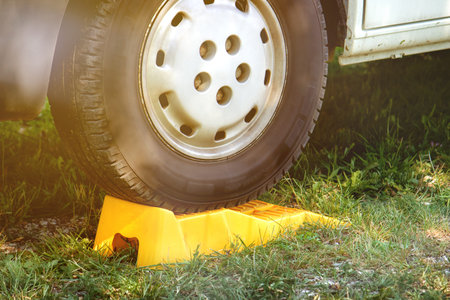 Parking stop for car wheel. Plastic object used to prevent the wheels from moving