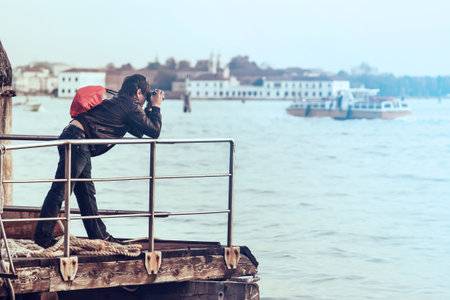 tourist takes a picture in venice, copy space available on the right