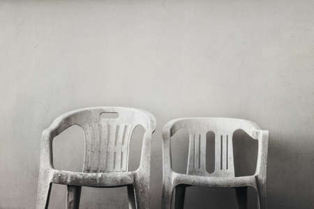 two ruined chairs, old empty plastic objects with copy spaceの写真素材