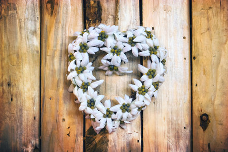 heart made of flowers on wooden background, love concept
