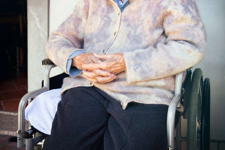 Senior woman on wheelchair. Old lady (hands detail)の写真素材