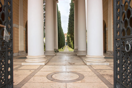Entrance of urban cemetery. Ancient building with columns in Udine - Italy (San Vito cemetery)