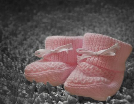 Newborn pink baby booties の写真素材
