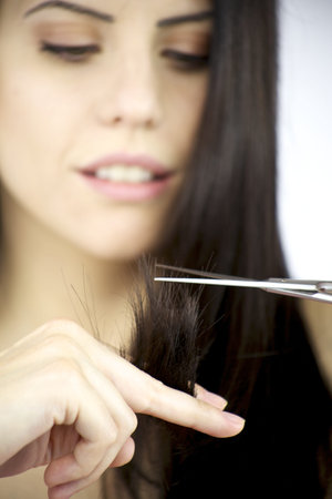 Gorgeous female model with black hair cutting split dead ends