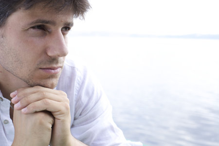 Good looking young man pensiveの写真素材