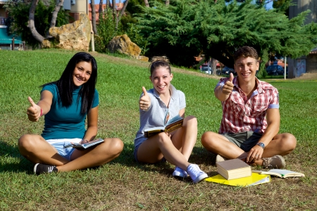 Good looking teenager smiling and having fun studying in parkの写真素材